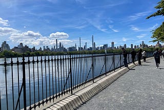 A sunny day and a view of the midtown skyline in NYC from the Reservoir