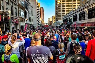 Runners line up at the start line of a marathon.