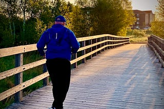 An image of the author running during sunrise in the early spring.