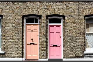The writer pictures two exterior doors, one pink and one orange.