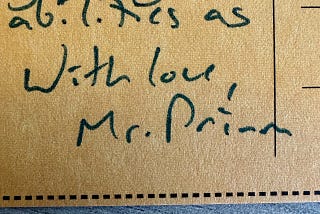 A macro image of a cardboard postcard. Handwritten text reads, “With love, Mr. Primm”.