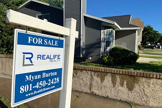 For sale sign at suburban home