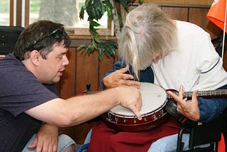 Patrick giving a banjo lesson at Camp Adventure 2010