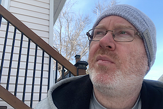 Man thinking while sitting on the steps.