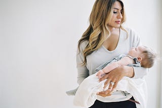 woman cradling baby