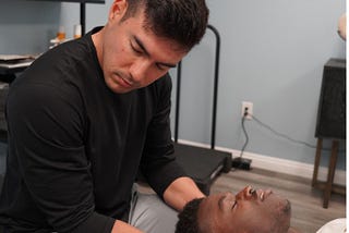 Tyler Bigenho performing chiropractic care on client