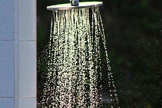 Round showerhead, water spraying in rainbow of colors