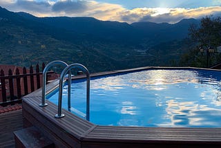 A hot-tub with a view across a green valley, from the side of hotel Archontiko at Metsovo village, Greece.