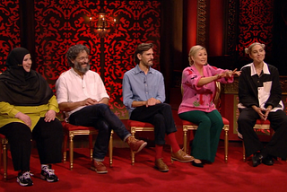 Rosie attempting to explain her prize task as the rest of the cast look on.