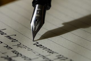 image of a fountain pen writing on a blank age