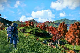 The customizable player character of No Man’s Sky (left) stands on a bluff looking out over a verdant forest planet, with a blue sky, lush green rolling hills, and some trees with orange leaves.