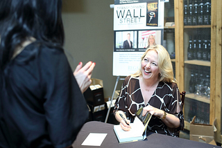 Kim Ann Curtin signing her book Transforming Wall Street