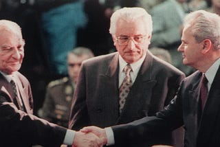 Bosnia’s Izetbegovic and Serbia’s Milosevic signing Dayton Peace Accords, 1995, to stop the war that had raged for three years