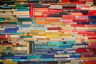 Books in all colors organized one on top of another.