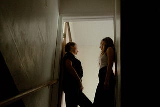 Two people conversing on the stairway