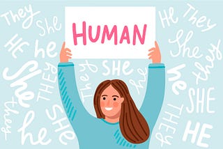 Woman holding up a sign that says “Human” while the background says “She, He, They”