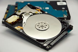 How should you safely dispose of an old hard drive?