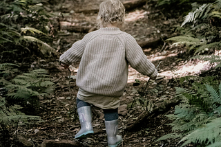little child running through forest