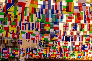 Flags from various countries hanging on lines.