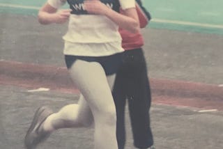 The author, running on a the track, competing in a race back in her younger days.