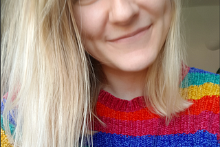 In a moment of lack of focus Hannah takes a selfie in her rainbow jumper.