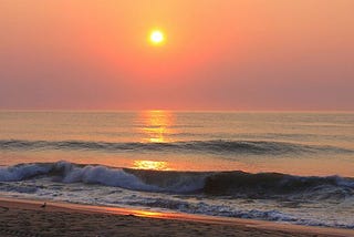 A beautiful view of the beach together with the sunrise.