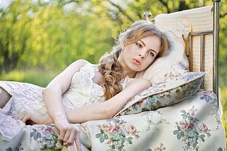 Girl in bed looking wistful