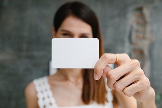 Person showing the camera a blank business card