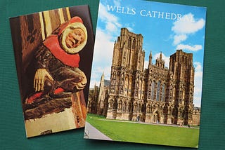 Two old guides for Wells Cathedral, showing a painted carving of a jester and the ornamental front facade of the church.