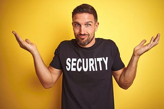 Man Shrugging Shoulders Wearing Security T-Shirt