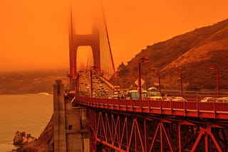 Cars crossing the Golden Gate Bridge in San Francisco under a smoky orange sky caused by California wildfires. Photo by bennymarty/Getty Images