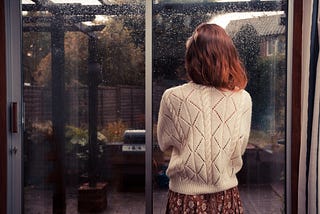 Woman looking out of the window.