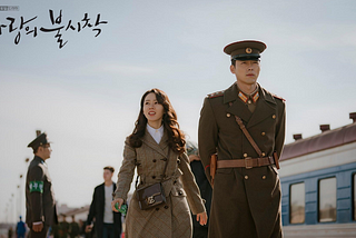 A screenshot of woman and officer at train station still from Korean drama Crash Landing on You