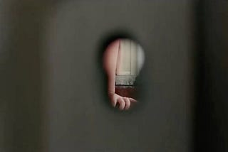 View of an arm through a keyhole