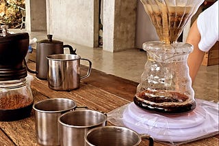 Drip coffee in forest on elevated concrete platform on a wooden table