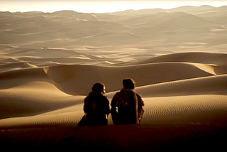 Chani (Zendaya) and Paul Atreides (Timothée Chalamet) out in the desert.