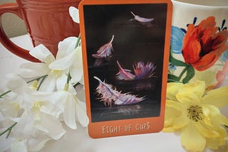 A tarot card depicting the eight of cups