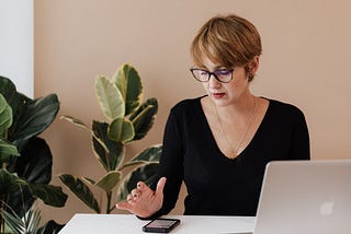 Midlife woman networking by search contacts in her phone