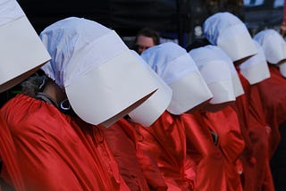 Protestors dressed as handmaids from Margaret Atwood’s iconic work.