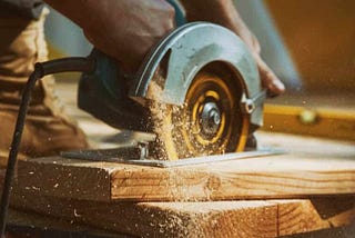 Circular saw cutting wood board