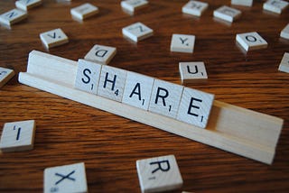 Scrabble letters of the word SHARE