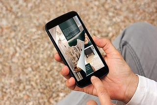 Online Magazine with a page flip effect on the smartphone in the hand of a person