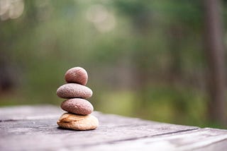 Four small rocks stacked atop each other