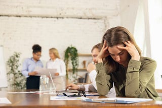 Exhausted employee thinking about quitting her job.