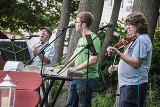 An Irish band with guitar, keyboard, and fiddle