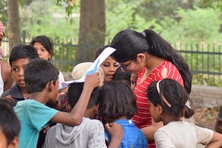 Photo : This was captured with me in the frame in a small slum in Hisar (Haryana) surrounded by enthusiastic young children learning how to draw and colour. Age group of children ranged from 5–15 years old.