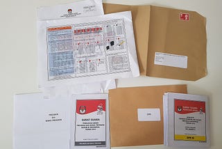 Postal voting package sent to an Indonesian voter in the United Kingdom for the 2019 general election. The grey-marked ballot is for the presidential election, while the yellow-marked ballot is for the legislative election for the Jakarta 2nd constituency (Central Jakarta, South Jakarta and abroad voters).