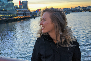 Lola standing on Blackfriars Bridge at sunset.