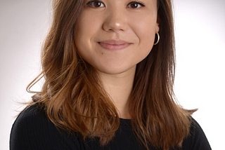 Woman with brown hair smiles at the camera,