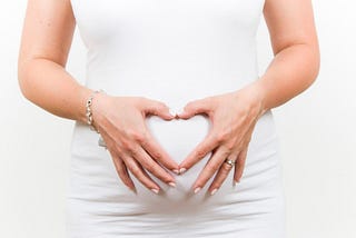 Pregnant woman holding her belly bum